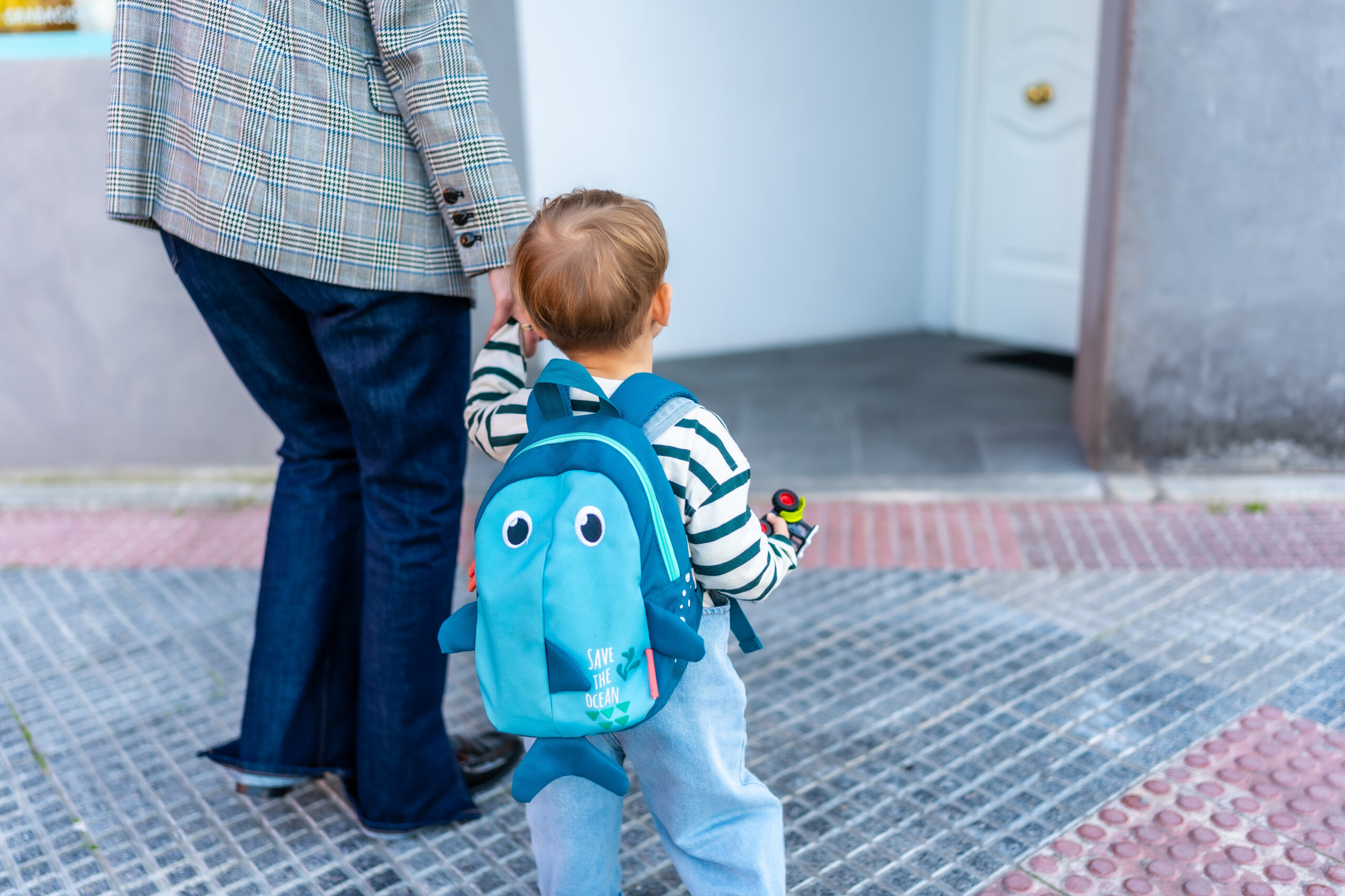 A grown-up walking through a forest with a child